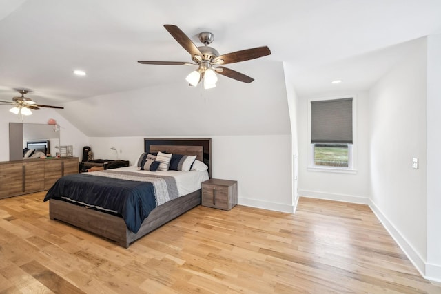 bedroom with ceiling fan, light hardwood / wood-style flooring, and lofted ceiling