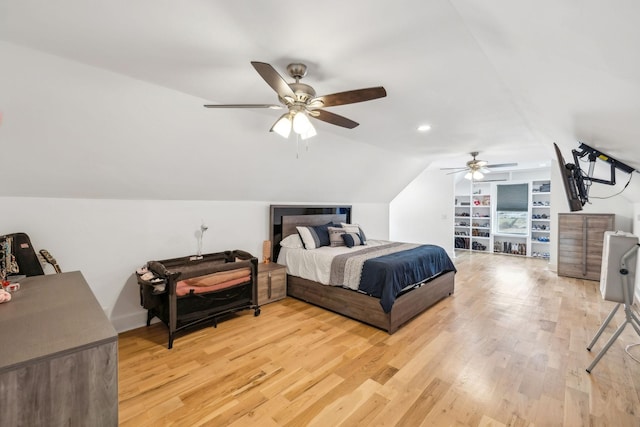 bedroom featuring ceiling fan, light wood-type flooring, and lofted ceiling