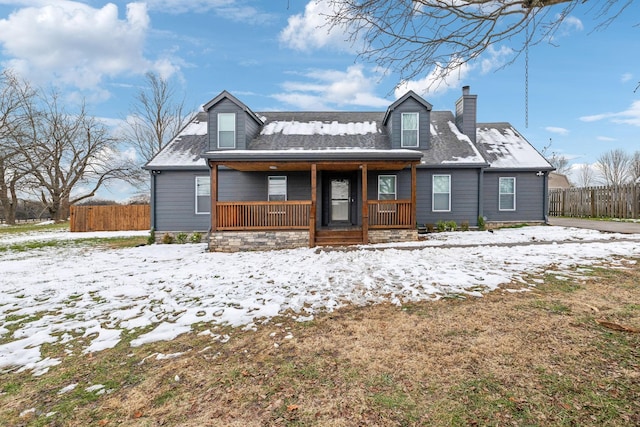 snow covered property featuring covered porch