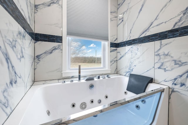 bathroom featuring tile walls and a bathtub