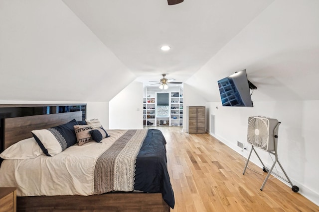 bedroom with lofted ceiling, hardwood / wood-style floors, and ceiling fan