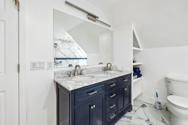 bathroom featuring lofted ceiling, toilet, and vanity