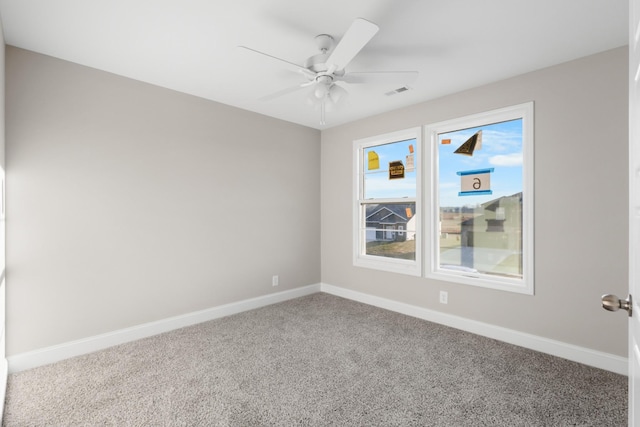 carpeted spare room featuring ceiling fan