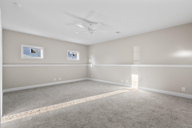 carpeted empty room featuring ceiling fan