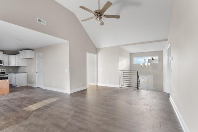 unfurnished living room with ceiling fan with notable chandelier, high vaulted ceiling, and dark wood-type flooring