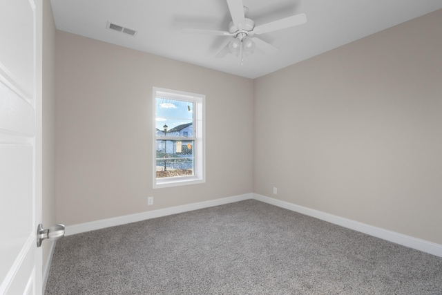 spare room featuring ceiling fan and carpet