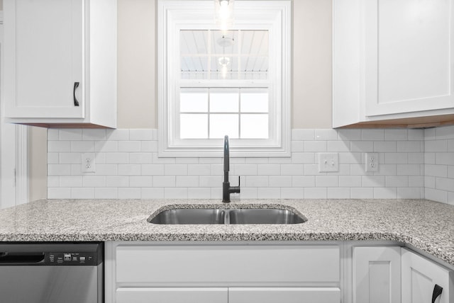 kitchen featuring dishwasher, decorative backsplash, sink, white cabinets, and light stone counters