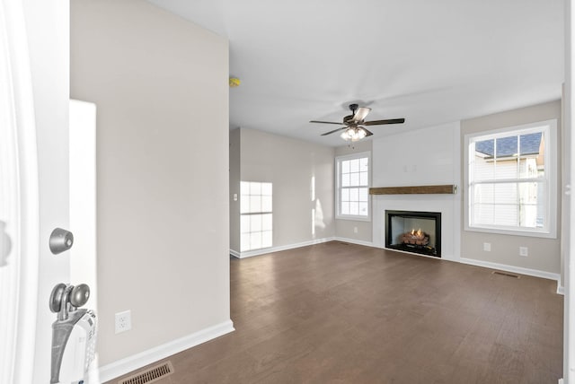 unfurnished living room with ceiling fan and dark hardwood / wood-style floors