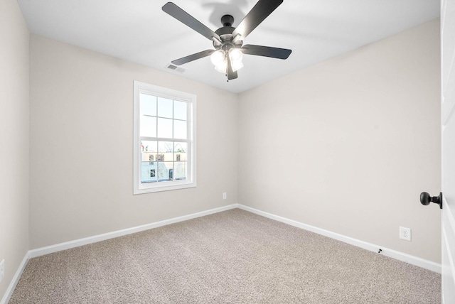 unfurnished room with ceiling fan and carpet