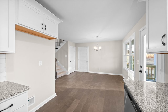 kitchen featuring an inviting chandelier, white cabinetry, decorative light fixtures, dark hardwood / wood-style flooring, and light stone countertops