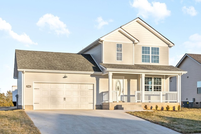 view of front of home with a garage, a front lawn, and a porch