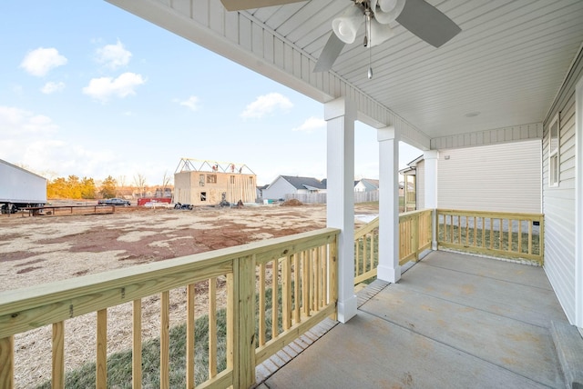 balcony featuring ceiling fan and a porch