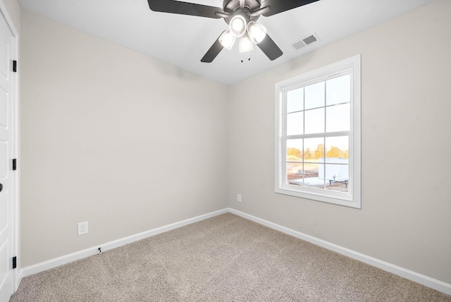 carpeted spare room with ceiling fan and a healthy amount of sunlight