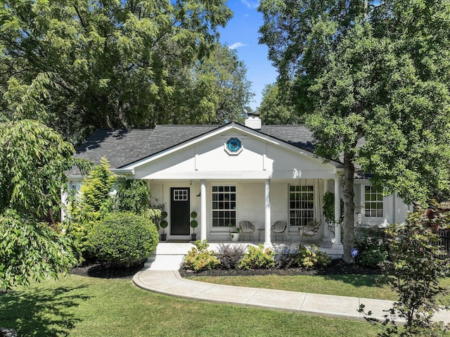 view of front of property with a porch and a front lawn