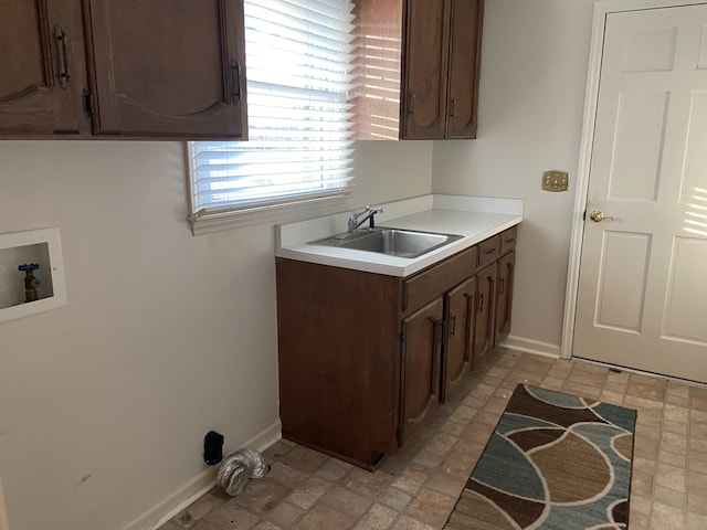 kitchen featuring dark brown cabinets and sink