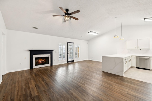 unfurnished living room with wood-type flooring, ceiling fan, and vaulted ceiling