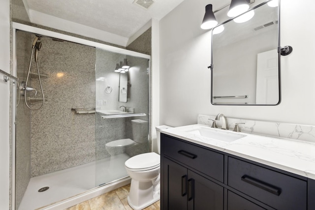 bathroom featuring toilet, an enclosed shower, and vanity