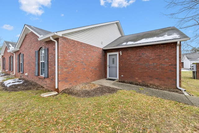 rear view of property with a yard