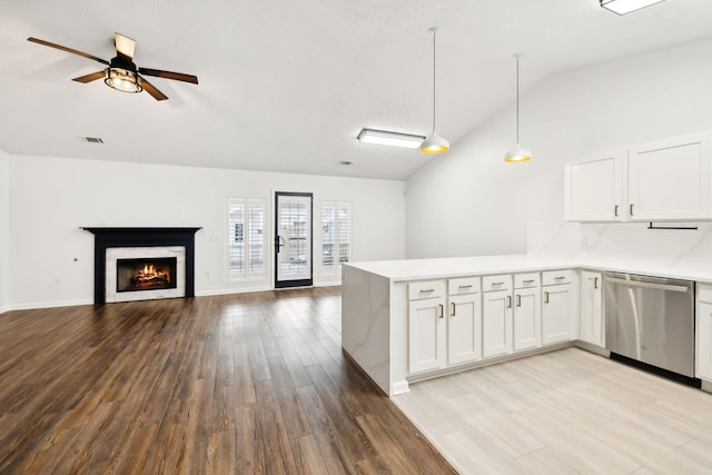 kitchen featuring white cabinets, dishwasher, pendant lighting, and kitchen peninsula