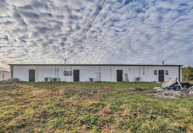 rear view of house featuring a lawn