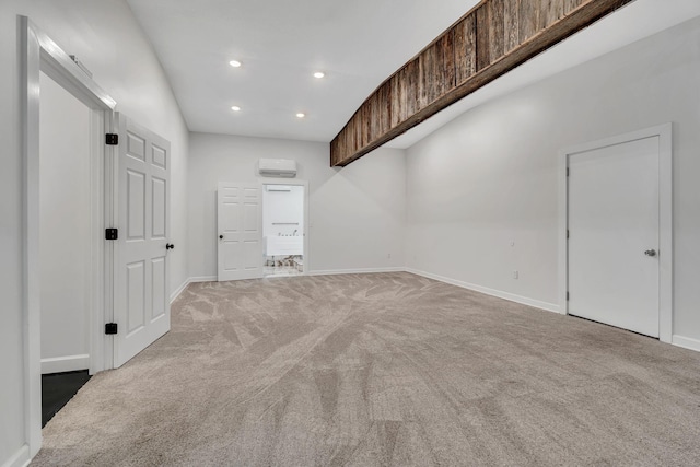 carpeted empty room featuring an AC wall unit