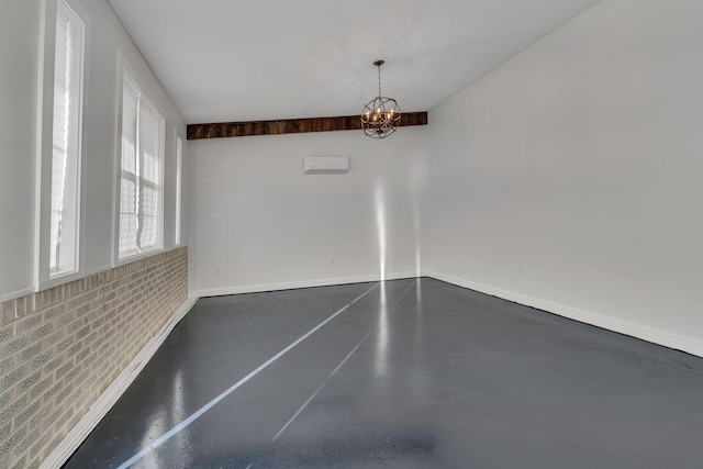 unfurnished dining area with concrete floors and a chandelier