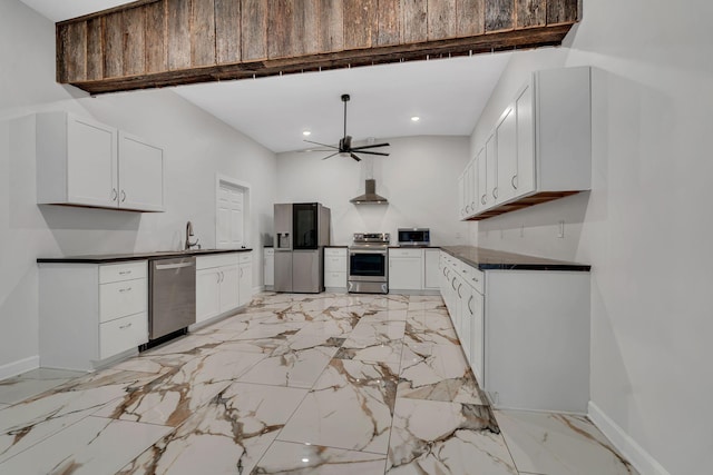 kitchen with sink, white cabinetry, wall chimney exhaust hood, ceiling fan, and appliances with stainless steel finishes