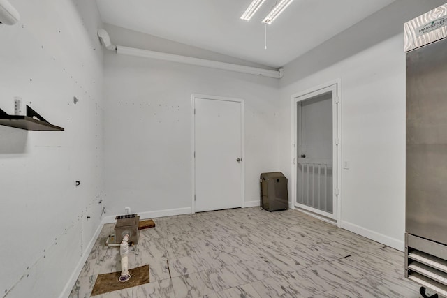 spare room with lofted ceiling