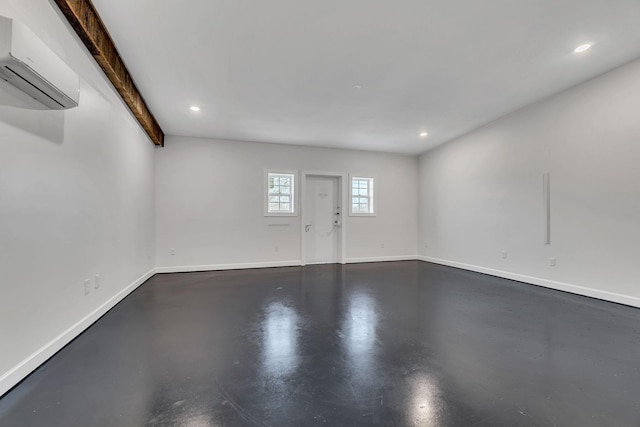 interior space with an AC wall unit and concrete floors