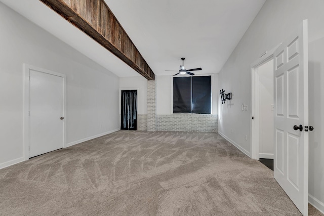 unfurnished living room with brick wall, ceiling fan, and light colored carpet