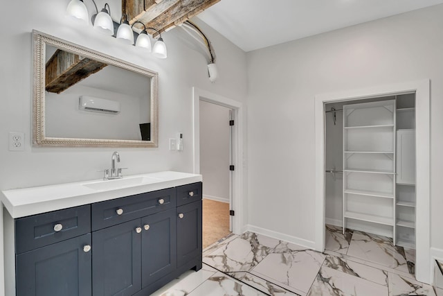 bathroom with a wall unit AC and vanity