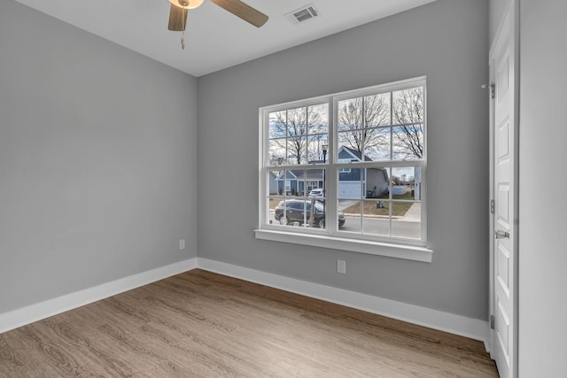 empty room with ceiling fan and wood-type flooring