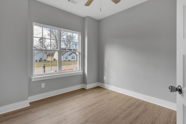 spare room with ceiling fan and hardwood / wood-style flooring