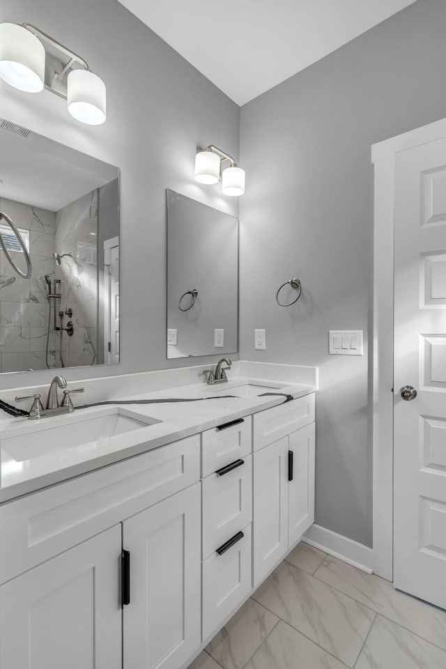 bathroom with vanity and a tile shower