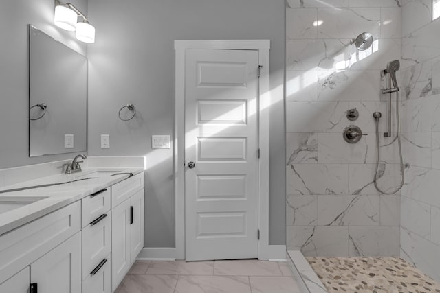 bathroom with vanity and a tile shower