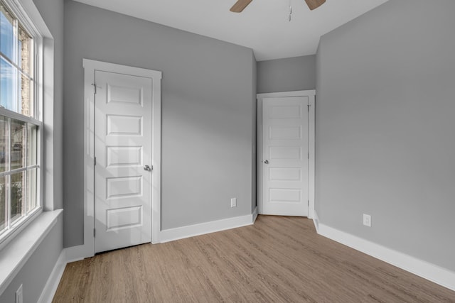 unfurnished bedroom featuring ceiling fan and light hardwood / wood-style floors