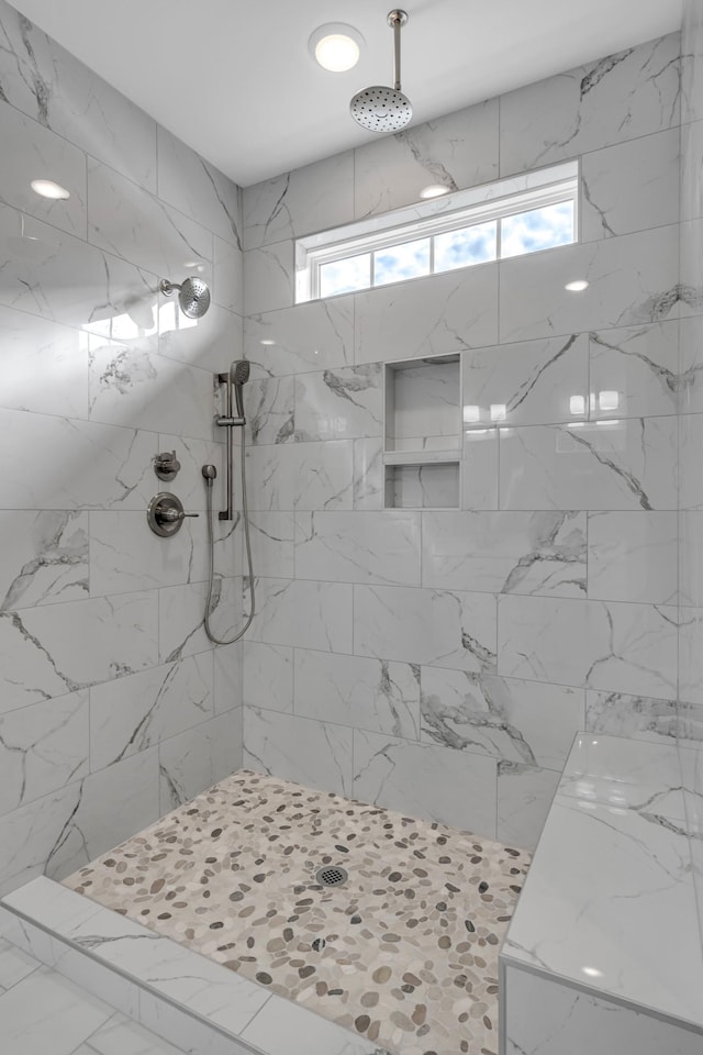 bathroom featuring a tile shower