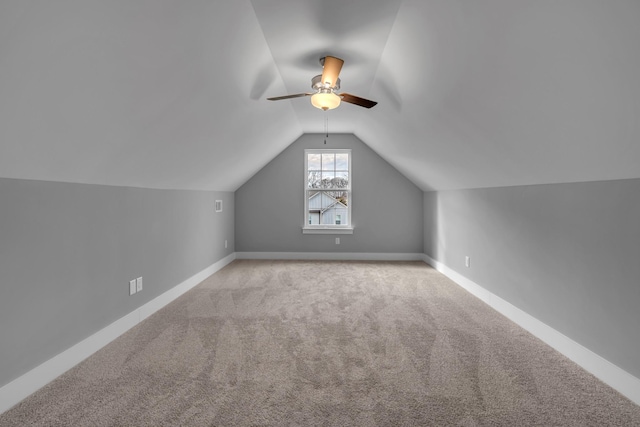 additional living space featuring ceiling fan, light carpet, and vaulted ceiling