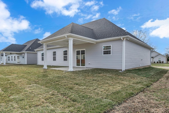 back of house with a patio area and a yard