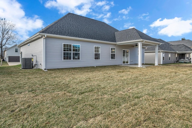 rear view of house featuring a patio area, cooling unit, and a lawn