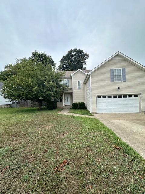 view of front facade with a front lawn and a garage