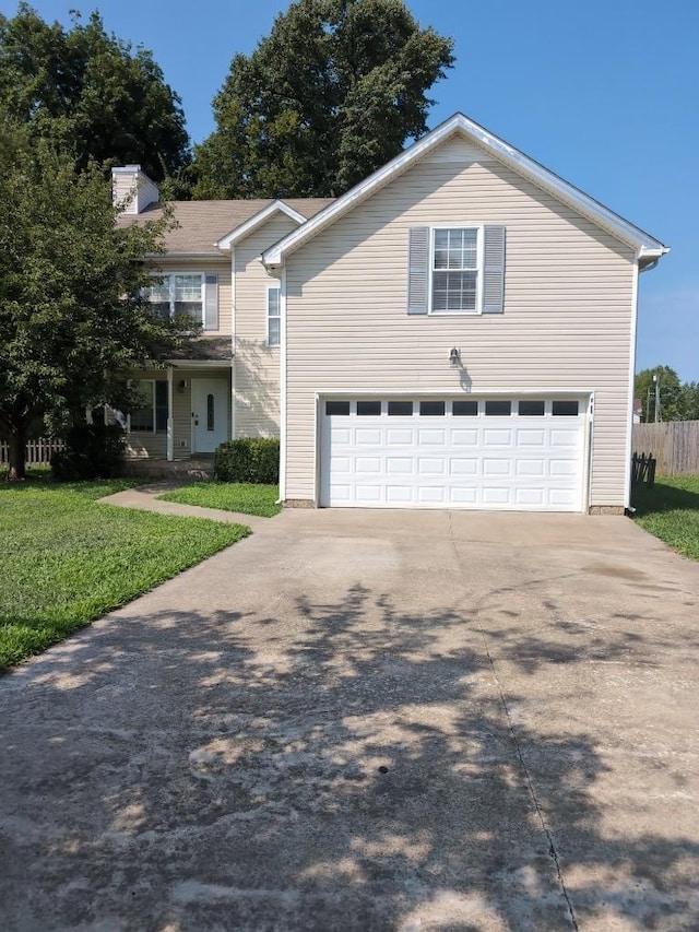 view of property with a front lawn and a garage