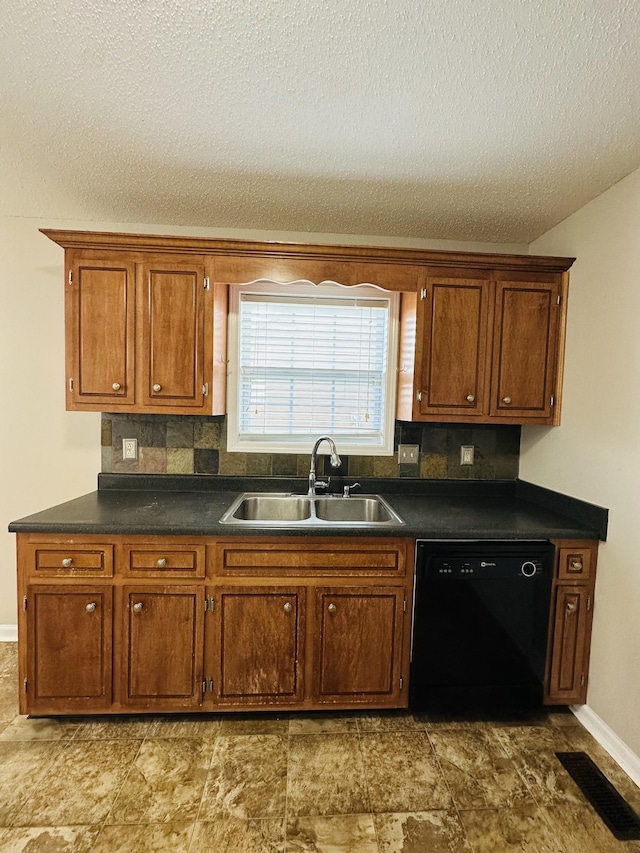 kitchen with sink, black dishwasher, and a textured ceiling