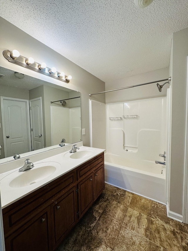 bathroom featuring vanity, a textured ceiling, and  shower combination