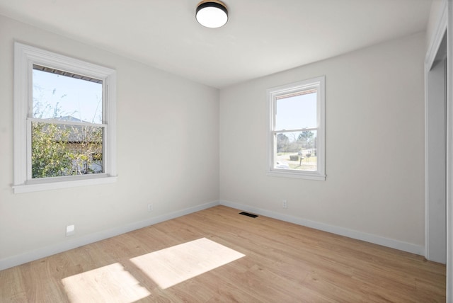 unfurnished room featuring light hardwood / wood-style floors