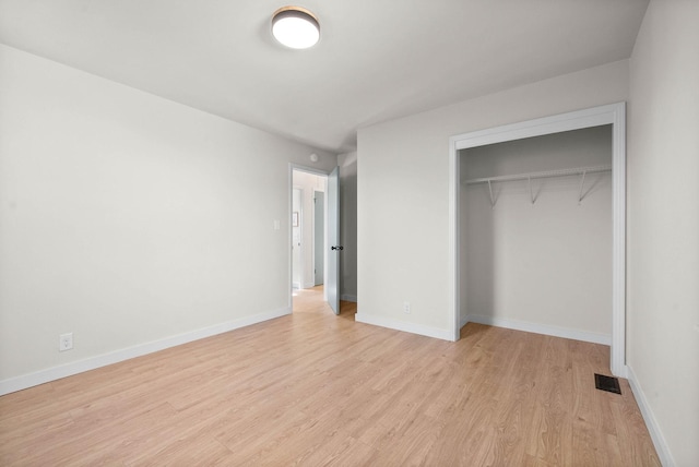 unfurnished bedroom featuring a closet and light hardwood / wood-style floors