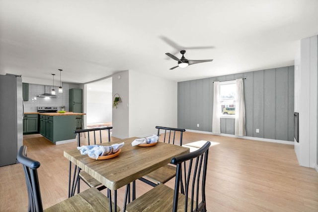 dining room featuring light wood-type flooring and ceiling fan