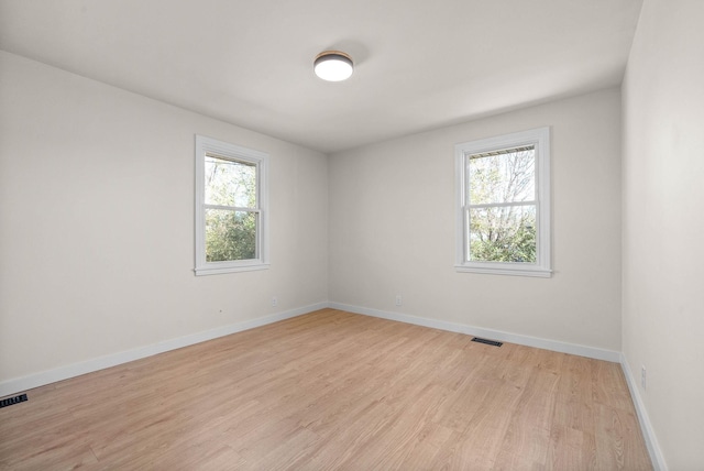 empty room with light hardwood / wood-style flooring