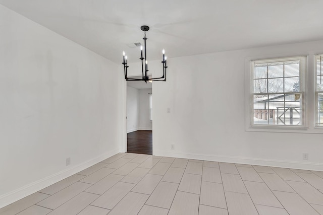 unfurnished dining area with a notable chandelier