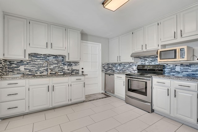 kitchen featuring backsplash, sink, appliances with stainless steel finishes, white cabinets, and stone countertops